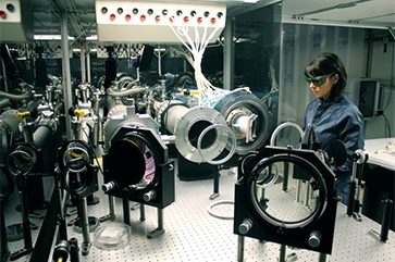 Carmen Constantin stands near Phoenix laser components