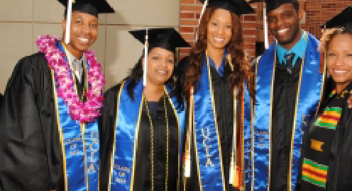 Two males and three female African American students in graduation regalia. From left to right, the students wear blue graduations sashes with golden accents; the student on the left wears a black sash with green, yellow and red decorative elements.