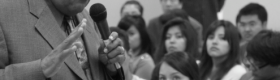 A black and white photograph of Rev. James Lawson Jr., a civil and labor rights icon, giving a lecture in a classroom with students listening attentively.