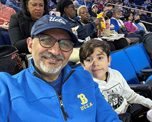 Alumnus Ihab Shahawi with his grandson at a UCLA basketball game.