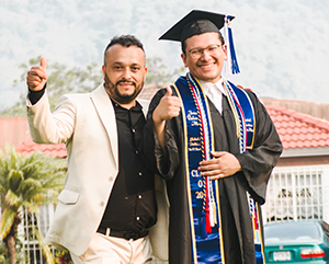 Jonathan Valenzuela Mejia, right, and father giving a thumbs-up