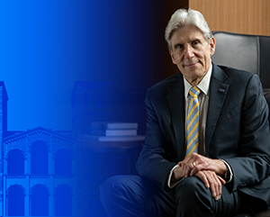 UCLA Chancellor-designate Dr. Julio Frenk seated in front of Royce Hall with partial blue tinted treatment