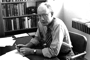 A black and white photograph of Professor Daniel Atkinson in his Haines Hall office in 1952.