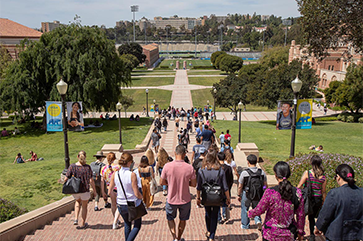 A large assembly of people going down Janss Steps on a sunny day.