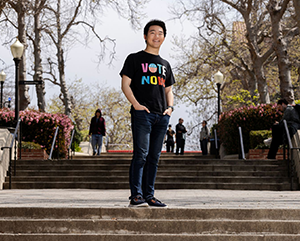 Shi wearing wearing a shirt that says, "VOTE NOW," on Bruin Walk.