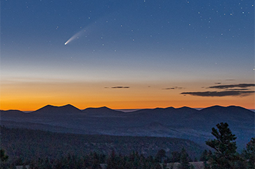 A photograph captured the NEOWISE comet from a cinder hill near the San Francisco Peaks in the Coconino National Forest in Flagstaff, Ariz.