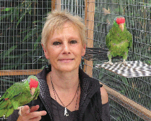 Ursula Heise with two parrots