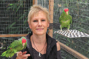 Ursula Heise with two parrots