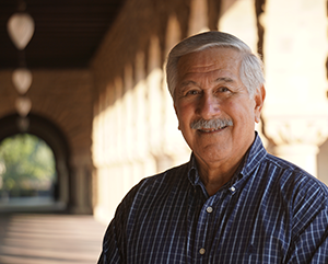 Albert Camarillo, in blue shirt, stands in Royce Hall portico