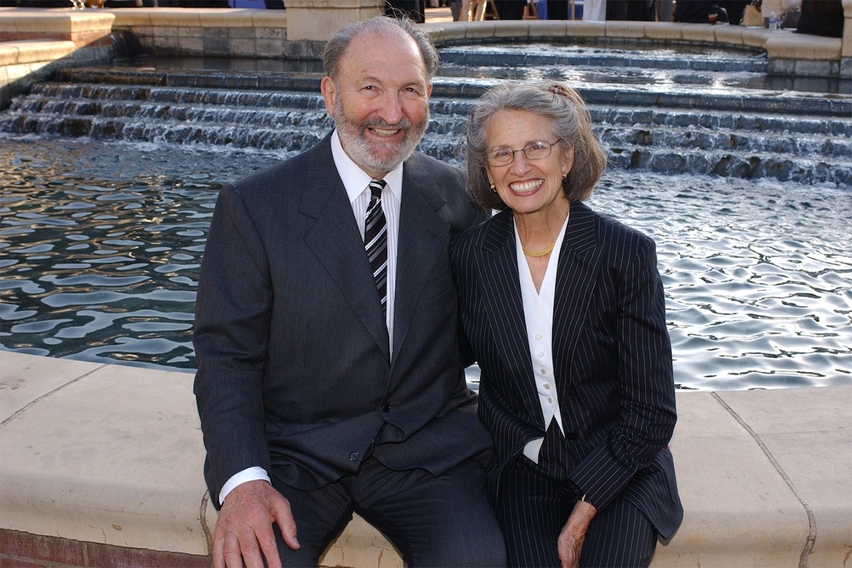 Ralph and Shirley Shapiro seated at edge of Shaprio Fountain on UCLA campus.