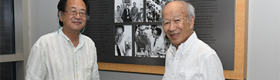 Mark Terasaki (left) and Richard Terasaki standing in front of a large plaque dedicated to the late Dr. Paul I. Terasaki.