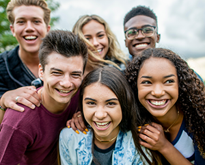 Six adolescents smiling for the camera