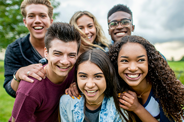 Six adolescents smiling for the camera