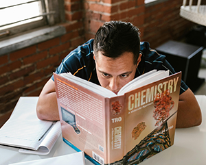 Student reading a chemistry textbook