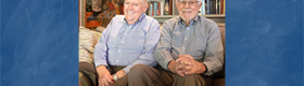 An image of Tom Bye (left) and David Bohne (right) sitting in a room with books and posters superimposed over a blue background.