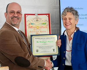 Steven Steinberg, L.A. County’s Geographic Information Officer, presents Pincetl with an award at the county’s 17th annual GIS Day.