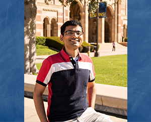 A photo of Pradip Gatkine in a red, white and black shirt in front of Royce Hall superimposed on a blue background.