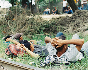 This image from 2017 shows a group of young Central American migrants and smugglers on the train tracks in Pakal-Ná, Mexico, a key migrant crossing zone in the southern state of Chiapas.