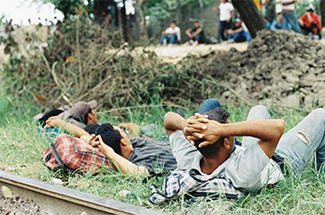 This image from 2017 shows a group of young Central American migrants and smugglers on the train tracks in Pakal-Ná, Mexico, a key migrant crossing zone in the southern state of Chiapas.