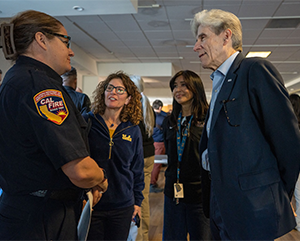 UCLA Chancellor Julio Frenk speaks with a representative of the California Department of Forestry and Fire Prevention at the opening of the disaster recovery center.