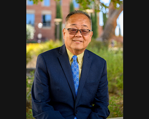 Keith Terasaki in a blue suit.