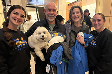 The UCLA softball team visits the Luskin Conference Center bringing their Bruin spirit to those evacuated due to the fires.