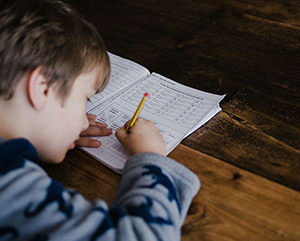 Photo of child at desk working on math problems