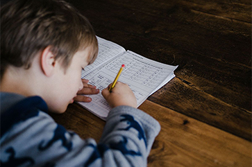 Photo of child at desk working on math problems