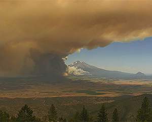 2021 Tennant Fire smoke rises in front of a mountain in Yreka, Calif.