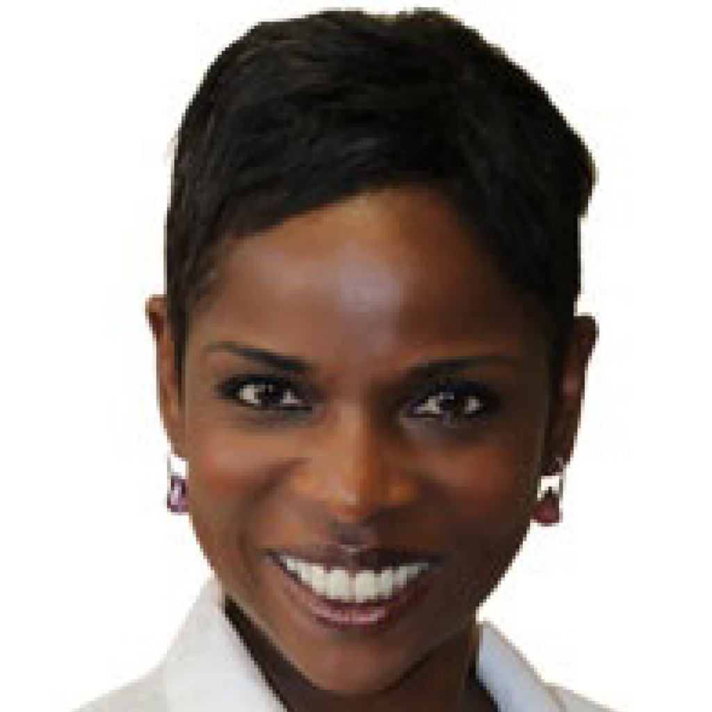 A woman with short dark hair, wearing earrings and a white top, smiling at the camera against a plain background.