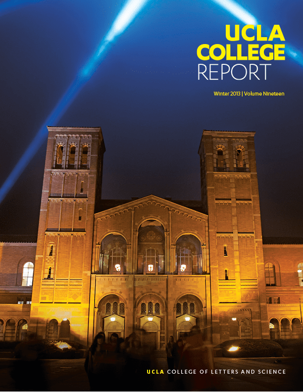 Nighttime photo of Royce Hall at UCLA, illuminated with yellow lights and blue spotlights shining in the sky, featured on the cover of the UCLA College Report, Winter 2013, Volume Nineteen.”.