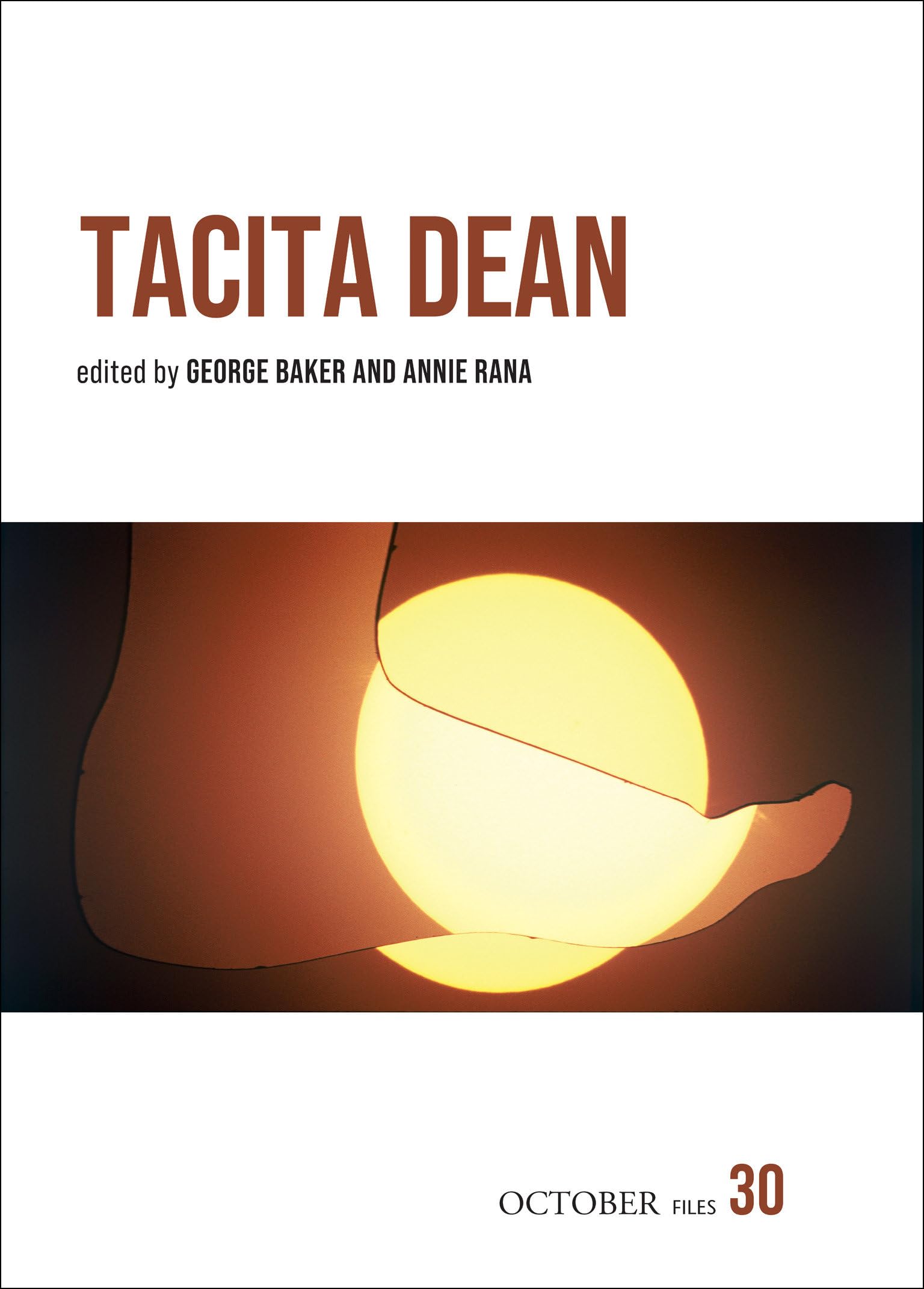 Book cover for Tacita Dean, edited by George Baker and Anne Rorimer. The cover features a glowing yellow circle partially covered by a hand, with the title and editors names above and OCTOBER files 30 below.