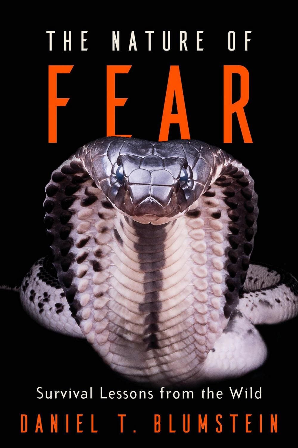 Book cover for The Nature of Fear by Daniel T. Blumstein, featuring a close-up image of a cobra with its hood expanded, set against a black background with bold orange and white text.